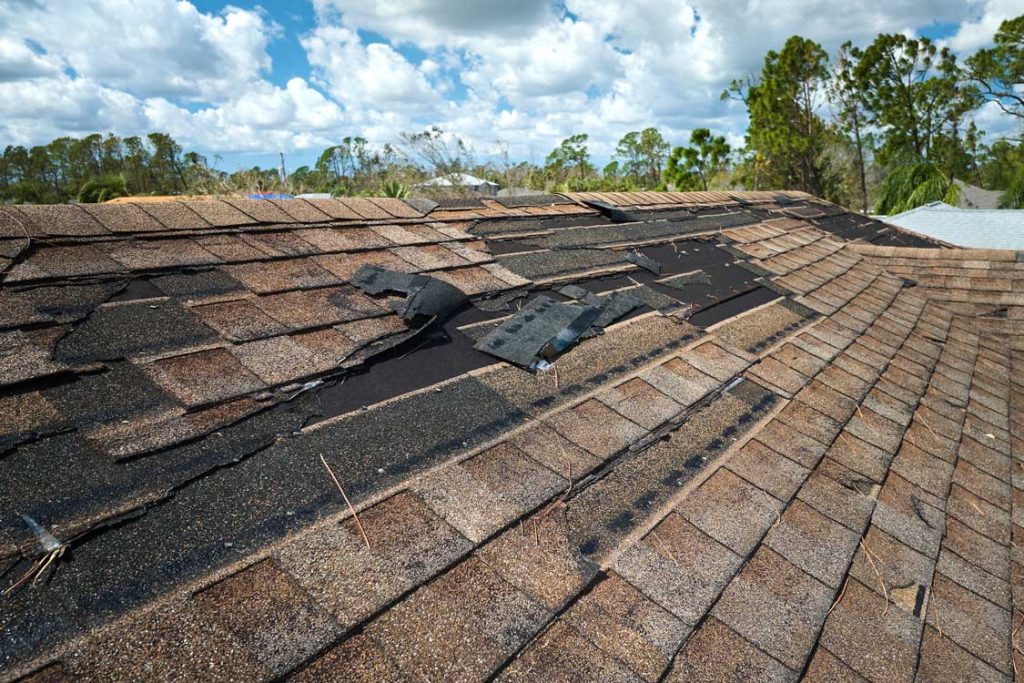 A close-up of a damaged roof, demonstrating the need for solutions for Wisconsin roofing problems