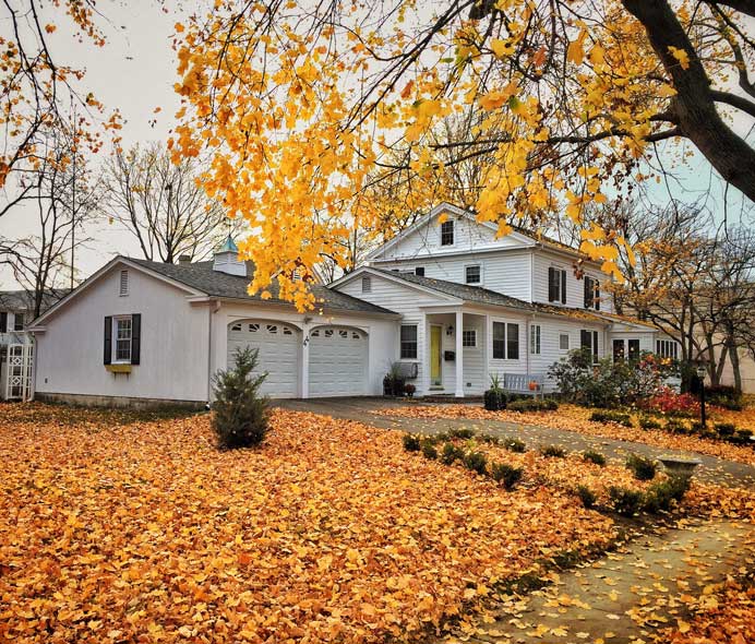 Wisconsin home in the fall, showing off the benefit of using quality Wisconsin roofing materials to maintain your roof all year long