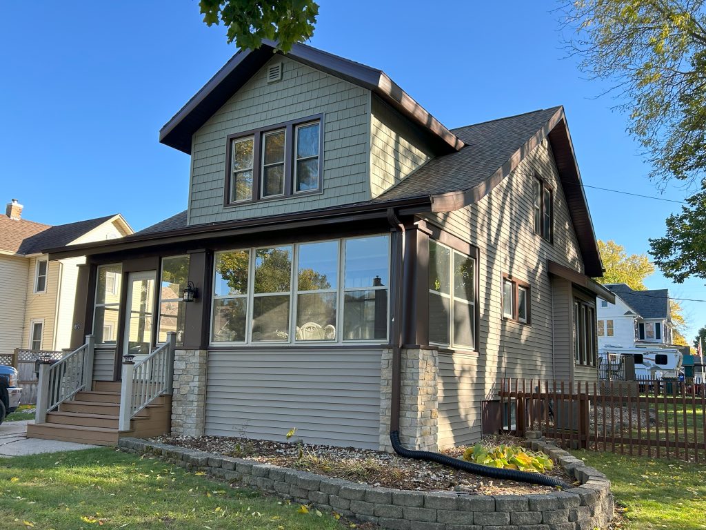 Close up of the exterior of a home, demonstrating how you can beautify your home exterior with an updated roof, gutters, windows, and siding